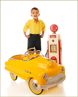 Child With Yellow Pedal Car